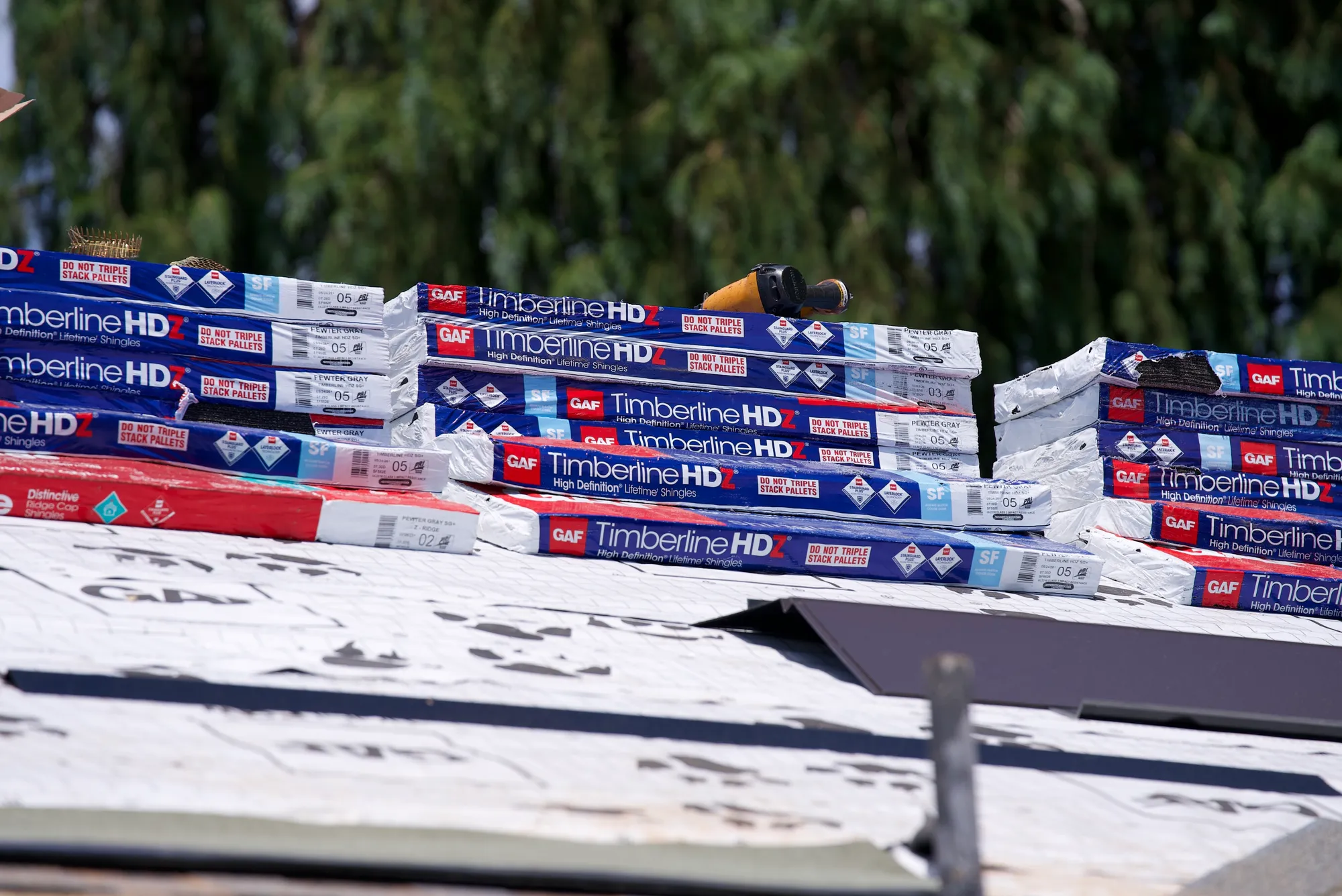 Rows of GAF Timberline HDZ shingle bundles staged on a roof in Hillsboro, OR