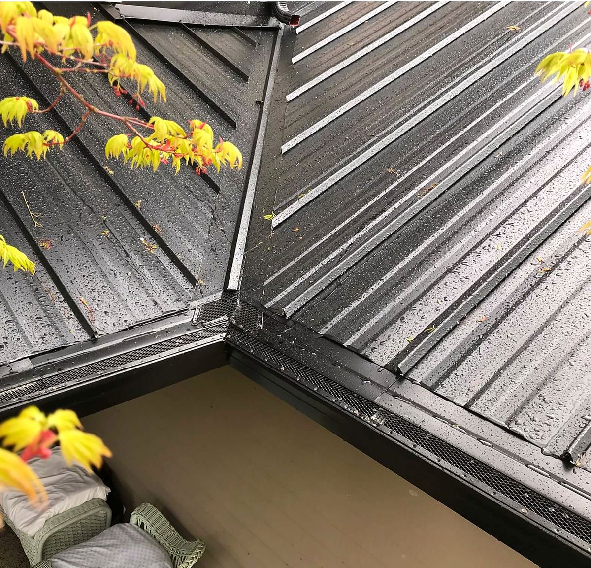 Gutter and valley detail channeling water off a shingle roof
