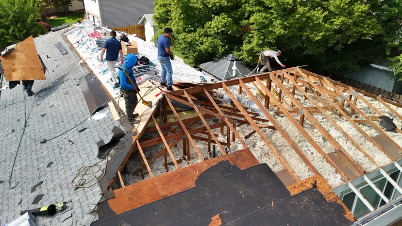 Aerial view of a Gladstone, OR roof mid-replacement with old shingles on one slope and exposed rafters on the other